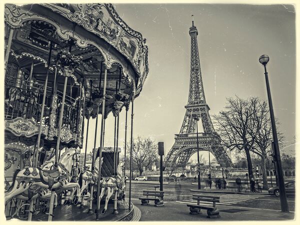 Carousel with the Eiffel tower in the background by Assaf Frank