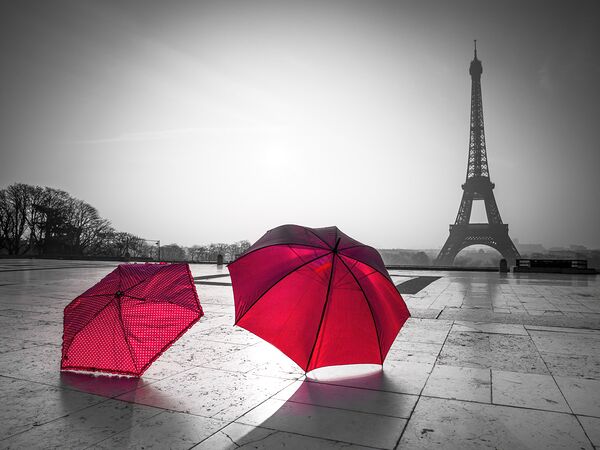 Two Umbrellas in front of the Eiffel tower Paris France by Assaf Frank