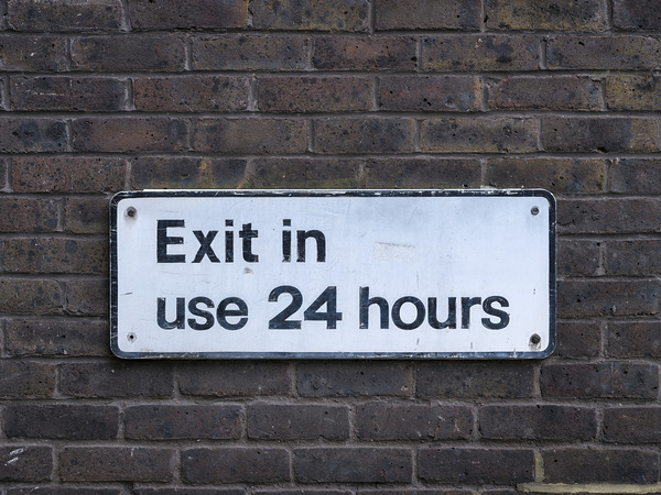 Sign board on brickwall by Assaf Frank