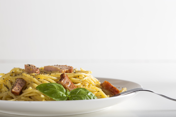 Spaghetti carbonara on white plate by Sebastian Radu