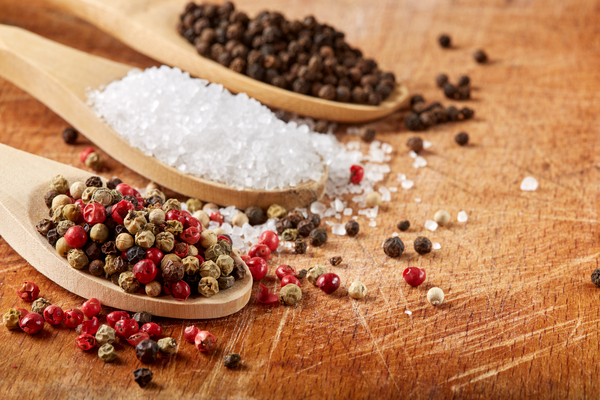 Colored peppercorns and sea salt in  wooden spoons  by Sebastian Radu