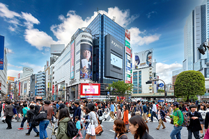 Shibuya Crossing in Tokyo during busy rush hour with many people
