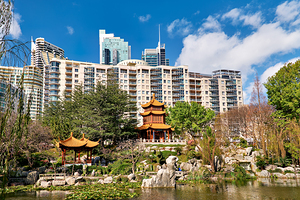 Chinese garden with pagodas and modern buildings
