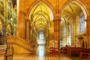 Interior of a grand cathedral with stained glass windows.