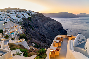 Sunset over Santorinis white village and caldera.