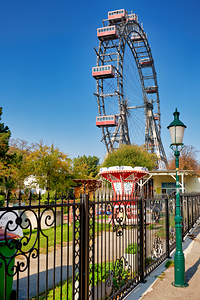 Prater Ferris wheel and carousel under a clear blue sky.
