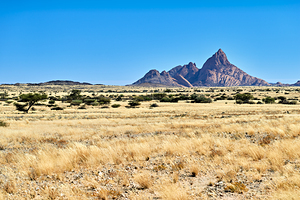 Granite peaks of Spizkoppe rise above the Namib Desert in Namibi