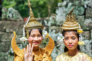 Cambodian dancers in golden attire and elaborate headwear.