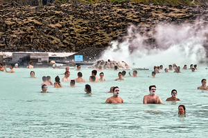Visitors enjoy Blue Lagoon SPA in Iceland while relaxing in warm