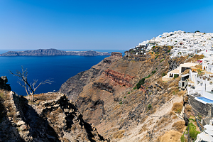 Picturesque Santorini: white village blue sea volcanic cliffs.