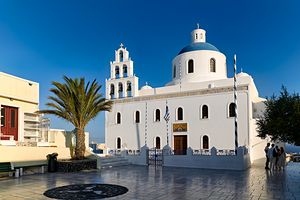 Beautiful white church blue dome palm tree clear sky.