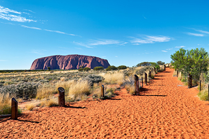 Uluru Australia: A path leads towards the iconic sandstone mono