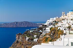Santorinis white village and blue domes overlooking the Aegean 