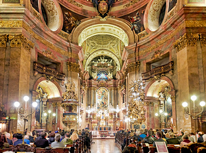 People attending a Requiem service in an ornate church.