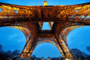 View of Eiffel Tower structure from below at dusk in Paris Fran
