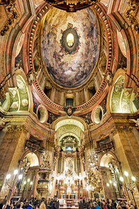 Stunning baroque church interior with painted dome and worshiper