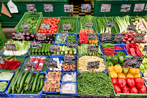 Fresh colorful vegetables and mushrooms for sale at a market.