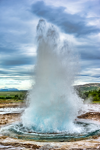 Fountain geyser Strokkur erupts in geothermal area of Iceland