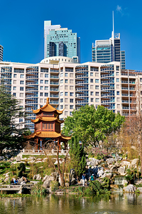 Traditional Chinese garden with modern skyscrapers in background