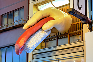 Giant sushi displayed on hand sculpture in Osakas Dotonbori are