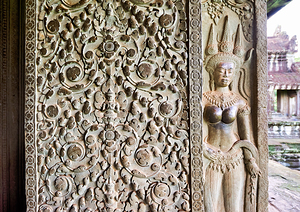 Intricate stone carvings of a deity and patterns at an ancient t