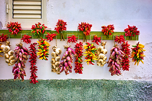 Vieste Gargano. Apulia Puglia Italy. Red chilishallot and garlic hanged to dry outside a house
