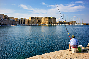 Salento. Apulia Puglia Italy. Gallipoli. A fisherman at the port