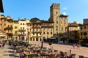 Arezzo Tuscany Italy. A group of people walking in Piazza Grande