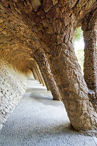 Barcelona. Catalonia. Spain. A colonnaded pathway in Park Guell designed by Antoni Gaudi