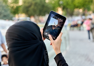Istanbul Turkey. Veiled woman taking a picture of Hagia Sophia with a tablet