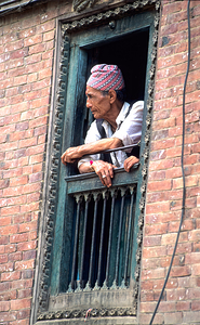 Nepal. Kathmandu. Man at a window