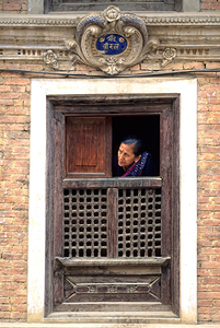 Nepal. Kathmandu. Woman a t a window