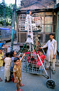 Pakistan. Children playing on a swing in Lahore