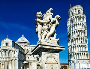 Pisa Tuscany Italy. Piazza dei Miracoli Square of Miracles. The Leaning Tower and fontana dei putti fountain with angels