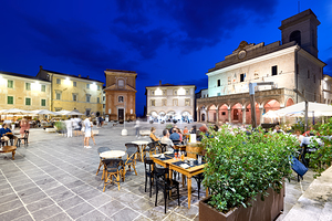 Montefalco Umbria Italy. Piazza del Comune at sunset. People eating out