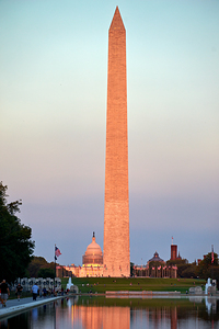 The Washington Monument and the United States Capitol at sunset reflected in the Lincoln memorial Pool. Washington D.C.