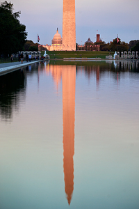 The Washington Monument and the United States Capitol at sunset reflected in the Lincoln memorial Pool. Washington D.C.