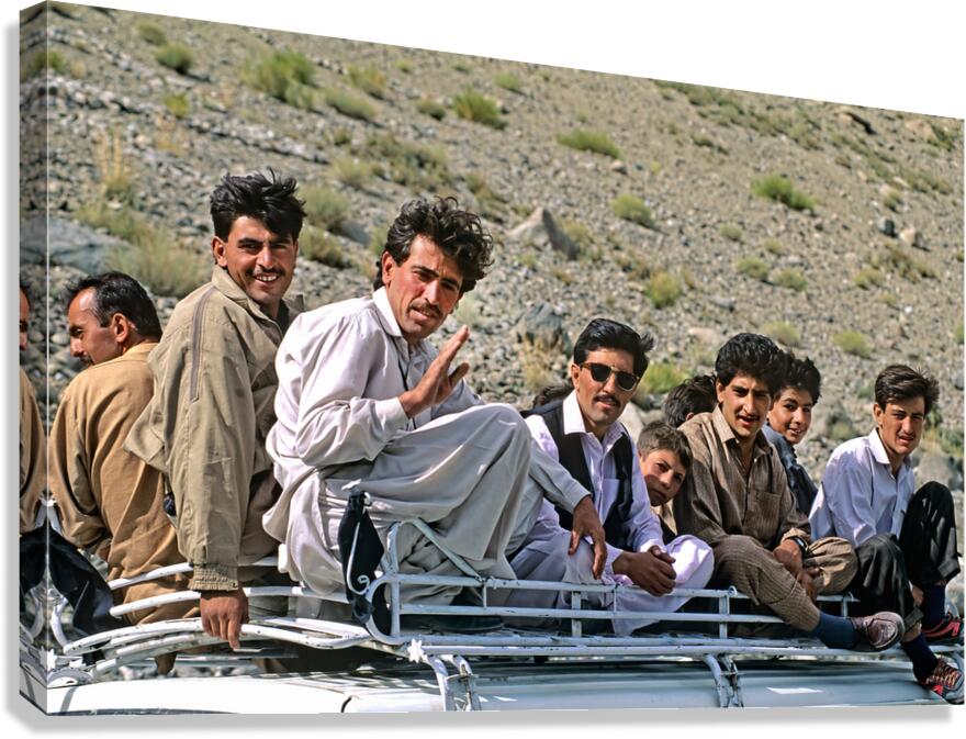 Pakistan. People travelling on the roof of a van Canvas Print