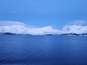 Norwegian fjord mountains shrouded in snow and ice