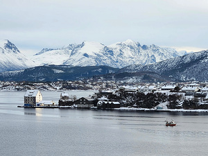 Norwegian fjord with mountains and fish storehouses