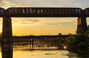Bridges behind the railroad bridge in Austin at sunset