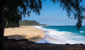 Powerful waves flow onto sand at Lumahai Beach Kauai