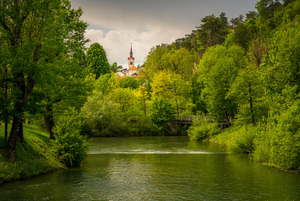 Church in the woods above peaceful river