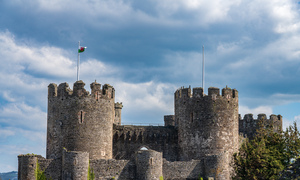 Flag flies over the historic Conwy castle in North Wales