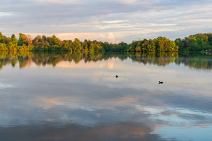 View across the Ellesmere Mere to a clear reflection of distant 