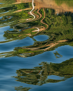 Sailboat on Nile River with ripples in the reflection from passi