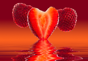 Fresh sliced strawberry in heart shape reflected