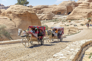 Tourists enjoying a horse drawn carriage ride through the ancien