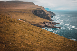  cliffs and the village on the island of Mykines Faroe.