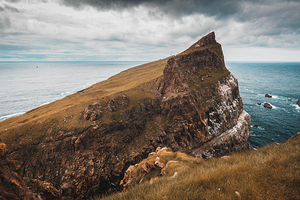 cliffs and the village on the island of Mykines Faroe.